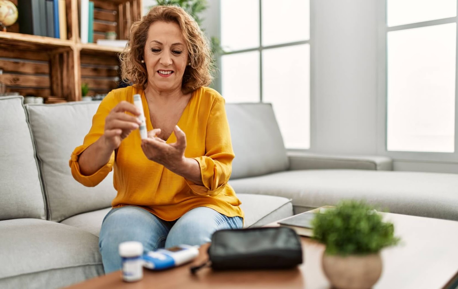 A person with diabetes uses a blood glucose monitor to check their blood sugar after a meal.