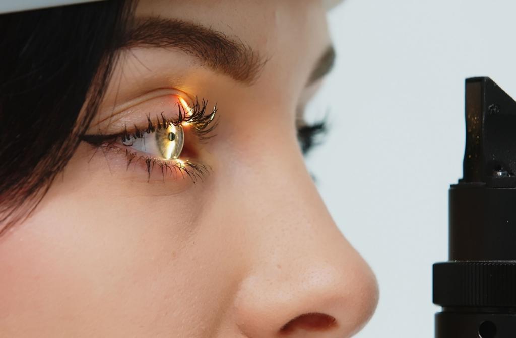 A close-up of a young woman who is undergoing a vision test